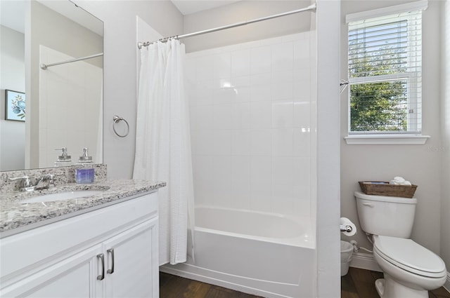 full bathroom featuring vanity, hardwood / wood-style flooring, shower / bath combination with curtain, and toilet