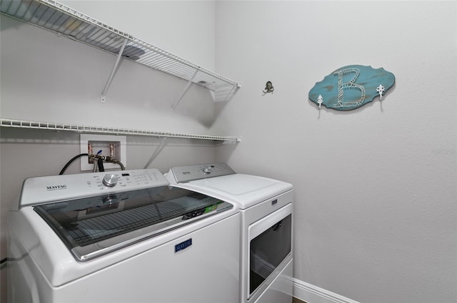 laundry area with washing machine and clothes dryer