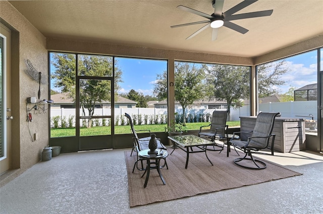 sunroom / solarium featuring ceiling fan and a healthy amount of sunlight