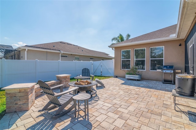 view of patio featuring area for grilling and a fire pit