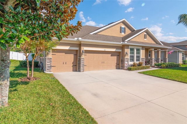 craftsman-style house featuring a garage and a front lawn