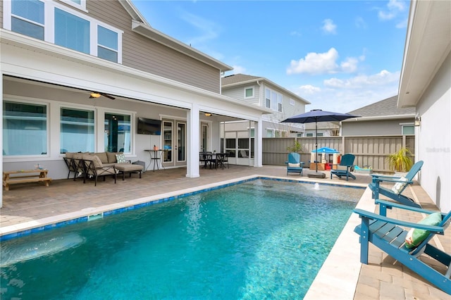 view of pool featuring fence, a fenced in pool, a ceiling fan, outdoor lounge area, and a patio area