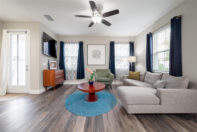 living room with ceiling fan and dark hardwood / wood-style flooring