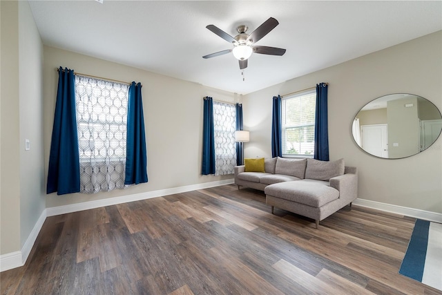 living area featuring hardwood / wood-style flooring and ceiling fan