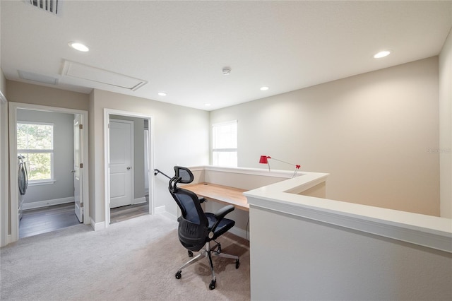 carpeted home office with plenty of natural light