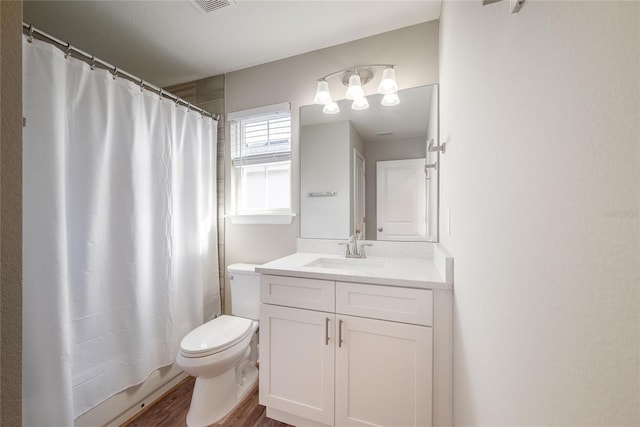 bathroom featuring a shower with shower curtain, vanity, toilet, and hardwood / wood-style floors