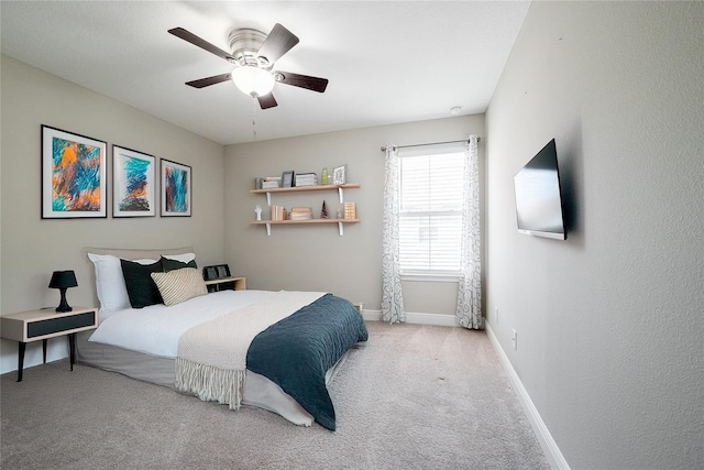 bedroom with ceiling fan and light colored carpet