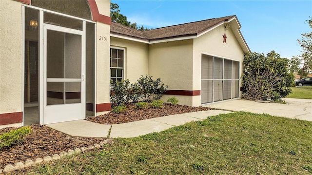 view of home's exterior with a garage and a lawn