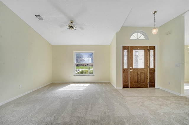 carpeted foyer entrance with ceiling fan