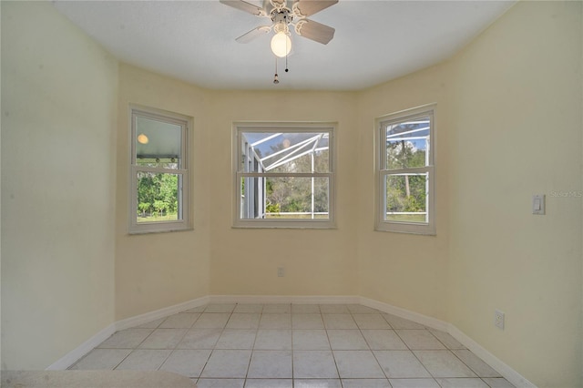 tiled empty room featuring ceiling fan