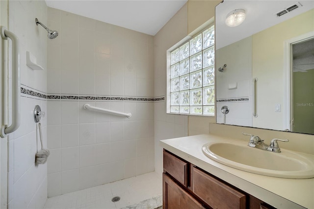 bathroom featuring vanity and a tile shower