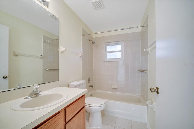 full bathroom with vanity, tiled shower / bath, tile patterned floors, and toilet