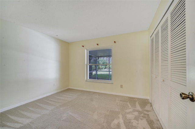 unfurnished bedroom featuring a closet and light carpet