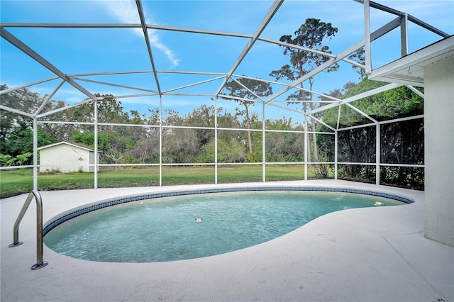 view of pool with a yard, a patio area, and glass enclosure