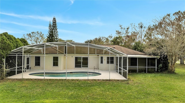 rear view of house with a yard, a lanai, and a patio area