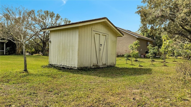 view of outbuilding featuring a yard