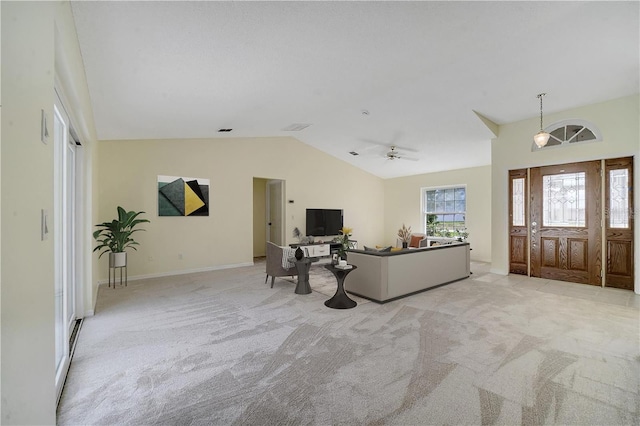 entrance foyer featuring vaulted ceiling and light carpet