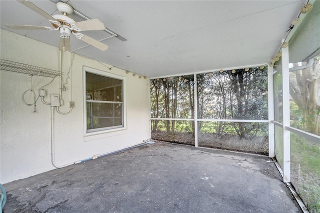 unfurnished sunroom with ceiling fan