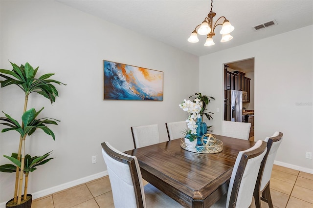 tiled dining space with a notable chandelier