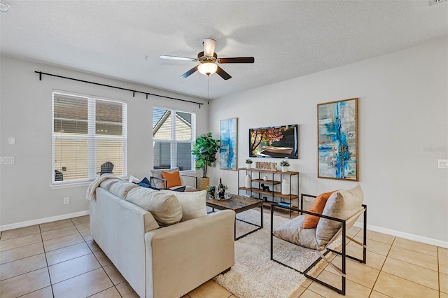 tiled living room featuring a textured ceiling and ceiling fan