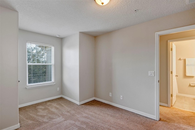 carpeted spare room with a textured ceiling