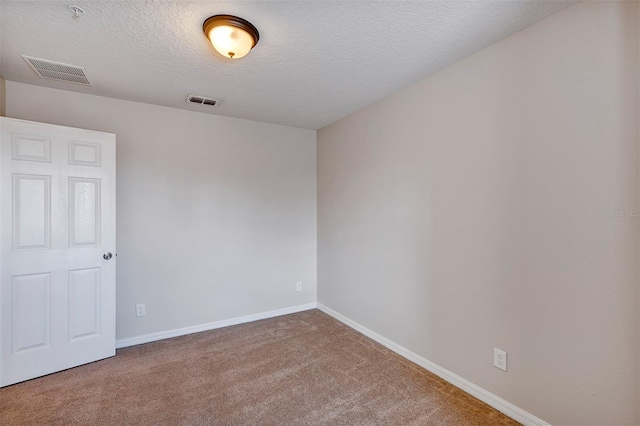 carpeted spare room featuring a textured ceiling