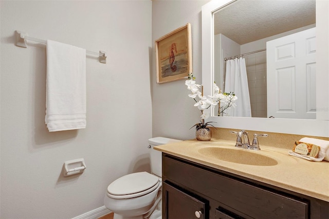 bathroom with vanity, curtained shower, a textured ceiling, and toilet