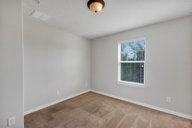 carpeted spare room with a textured ceiling