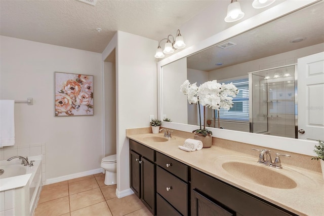 bathroom with a bathtub, tile patterned flooring, vanity, toilet, and a textured ceiling