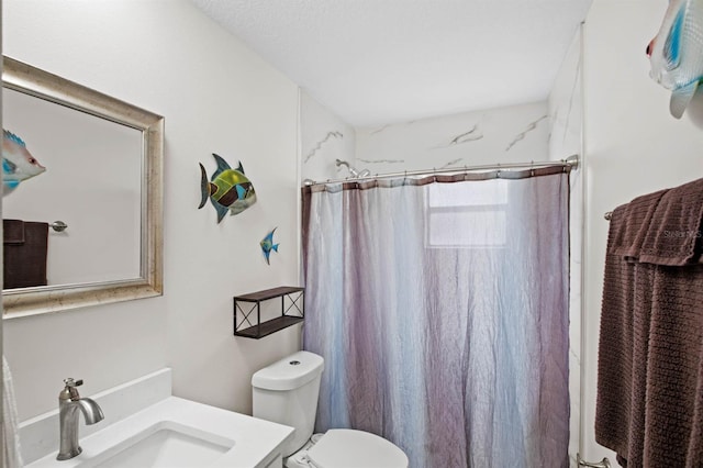 bathroom featuring vanity, curtained shower, and toilet