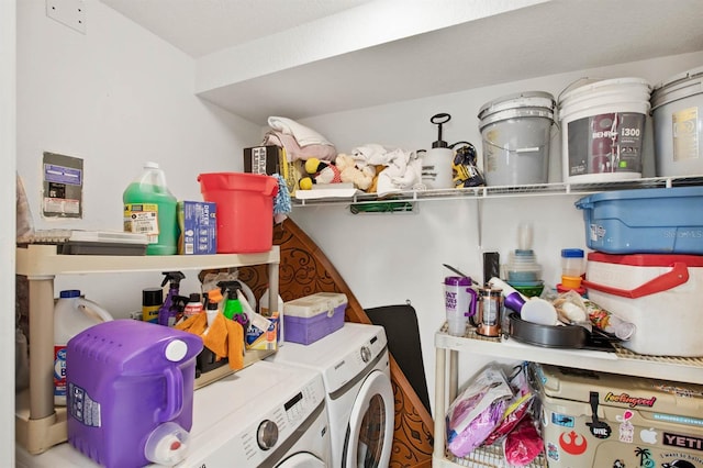 clothes washing area with washing machine and dryer