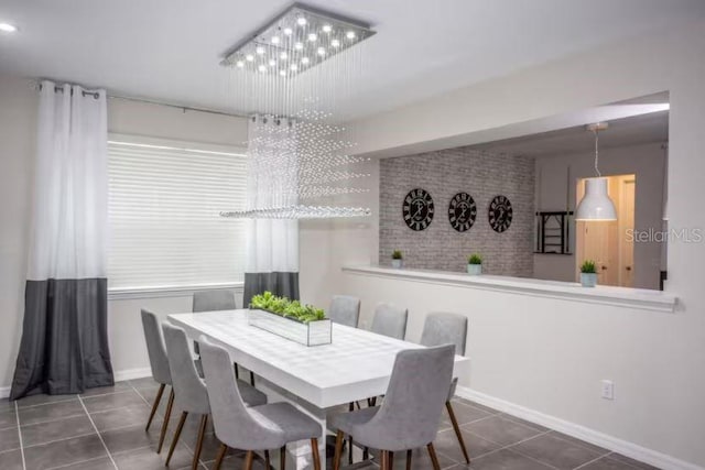 dining space with dark tile patterned floors