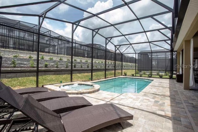 view of swimming pool with an in ground hot tub, a lanai, and a patio