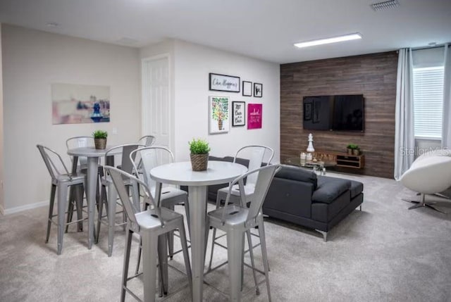 dining room featuring light carpet