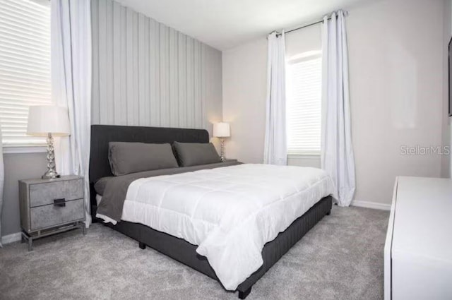 bedroom featuring light colored carpet