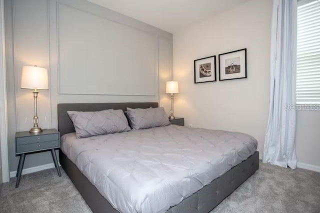 bedroom with carpet flooring and multiple windows