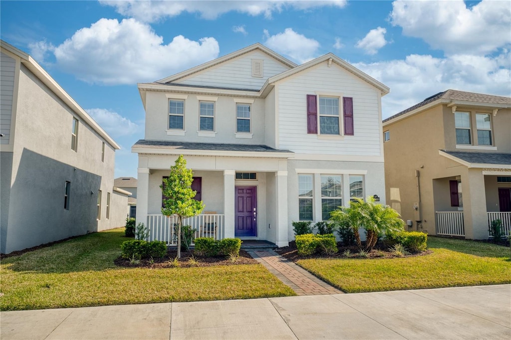 view of front of home with a front yard and a porch