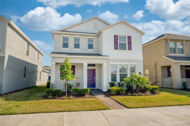 view of front of home with a front yard and a porch