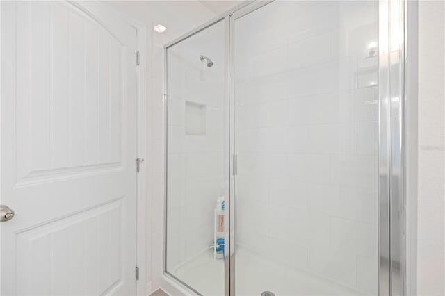 bathroom with a shower with door