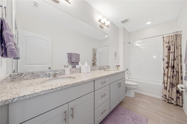 full bathroom featuring toilet, vanity, and shower / bathtub combination with curtain