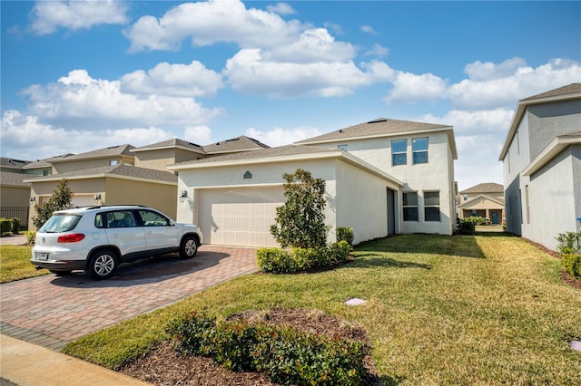 view of front of home featuring a garage and a front lawn