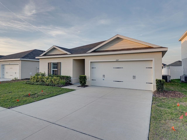 single story home featuring a garage, a front yard, and central air condition unit