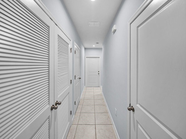 corridor with light tile patterned floors