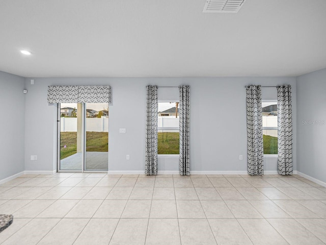 tiled empty room with a healthy amount of sunlight