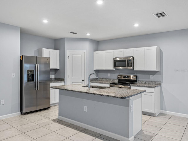 kitchen featuring white cabinetry, sink, stainless steel appliances, and a center island with sink