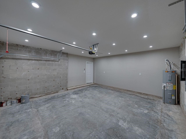 interior space with electric water heater and concrete floors