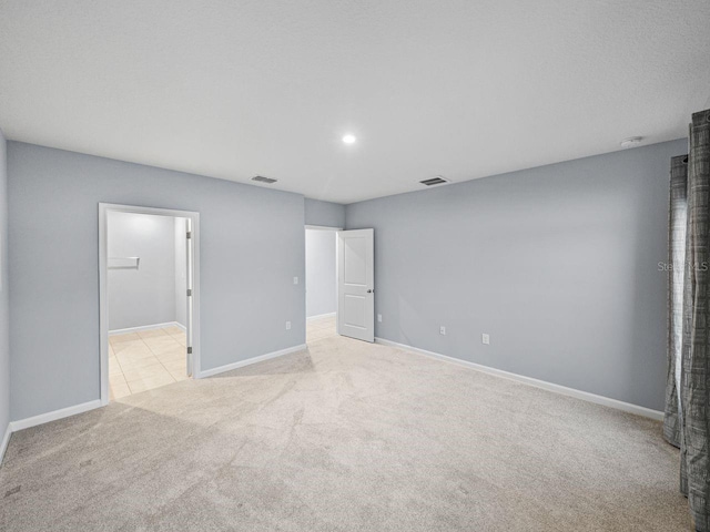 unfurnished bedroom with light colored carpet