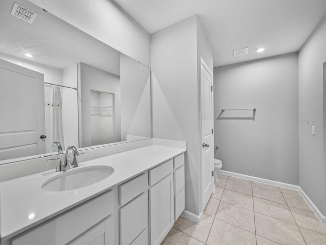 bathroom featuring tile patterned flooring, vanity, a shower with shower curtain, and toilet