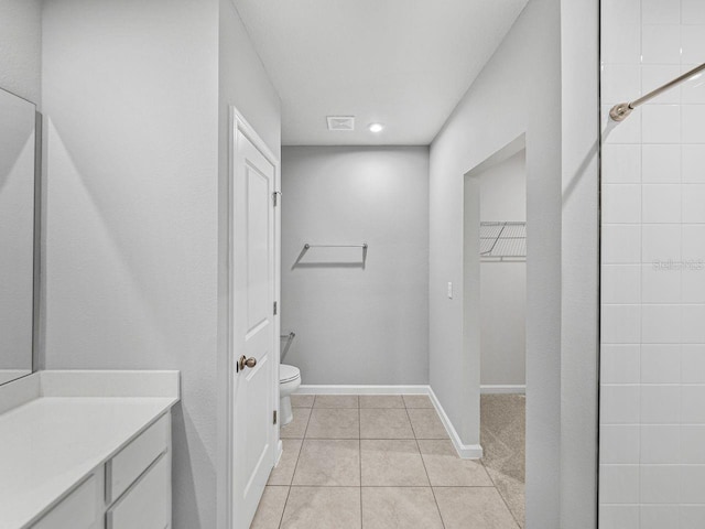 bathroom featuring vanity, tile patterned floors, and toilet