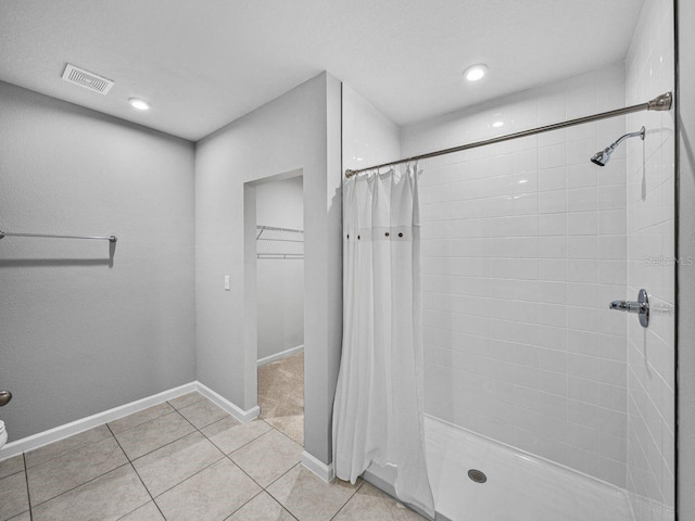 bathroom featuring tile patterned flooring and walk in shower